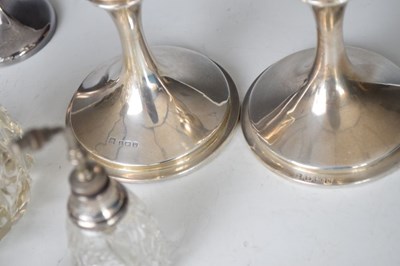 Lot 148 - Quantity of silver to include; bud vase, candlesticks and bottles