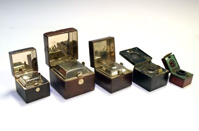 Lot 185 - Five late 19th and early 20th Century travelling inkwells, - travelling cases