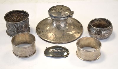 Lot 188 - George V silver capstan inkwell, four napkin rings and decanter label