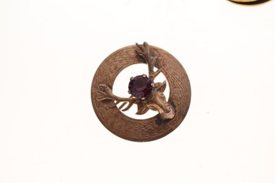 Lot 86 - Sterling silver brooch depicting a stag with a purple paste stone between the antlers