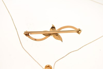 Lot 56 - 750 yellow metal and diamond bar brooch,, a 9ct brooch, and a 9ct pendant with chain