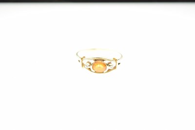 Lot 15 - Unmarked yellow metal dress ring, set faceted yellow sapphire and two diamonds