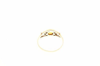Lot 15 - Unmarked yellow metal dress ring, set faceted yellow sapphire and two diamonds