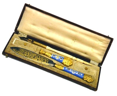 Lot 203 - Gilt metal and enamel cased letter opener and pen set