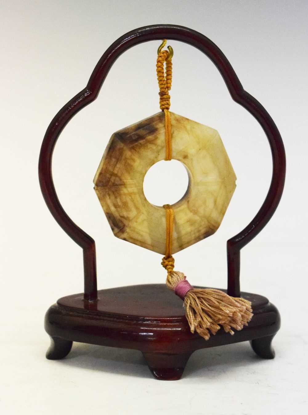 Lot 408 - Chinese jade 'Bi' disc on hardwood stand