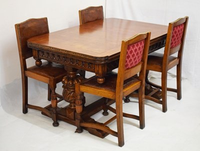 Lot 725 - Early 20th Century oak draw-out dining table and four studded tan hide chairs