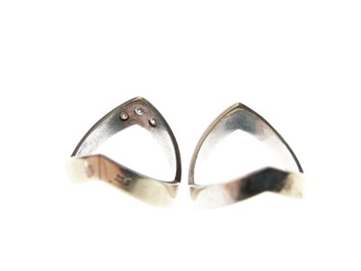 Lot 14 - Two white metal wishbone design rings