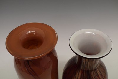 Lot 325 - Anthony Stern (1944-2022) - Red ground glass vase with swirled decoration and another vase