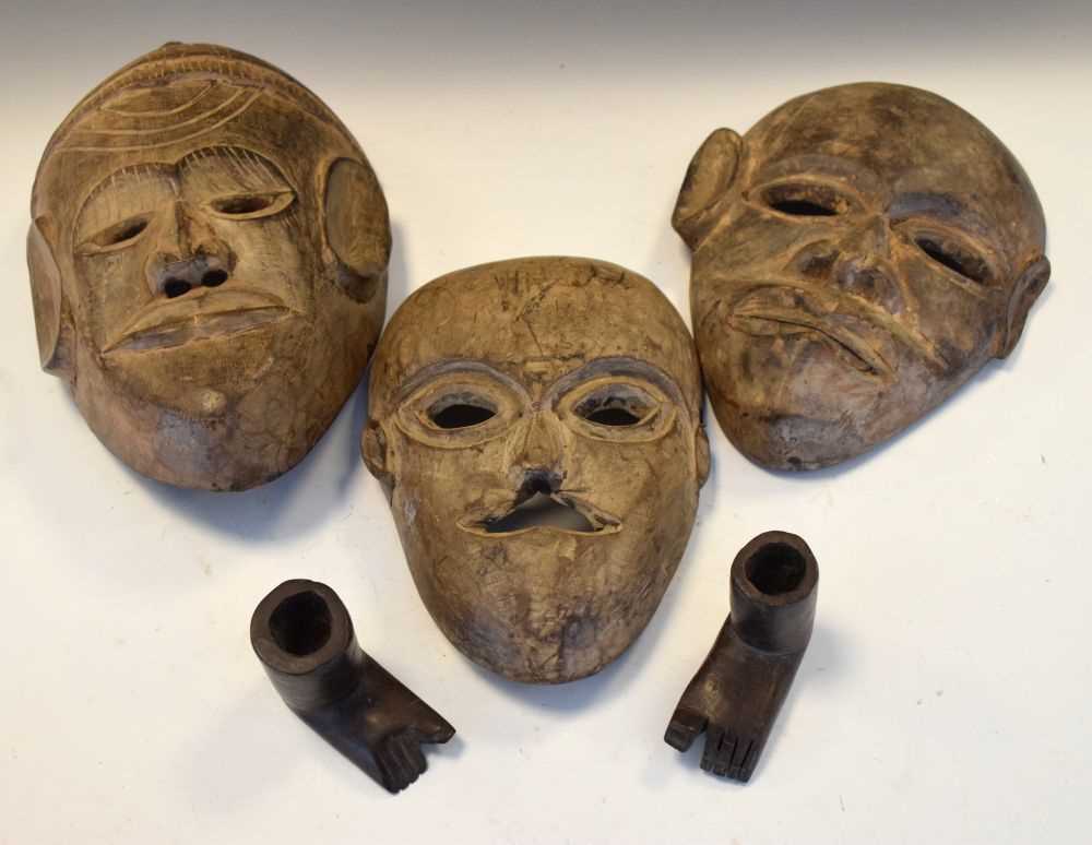 Lot 288 - Three African carved hardwood masks and pair of carved wooden feet