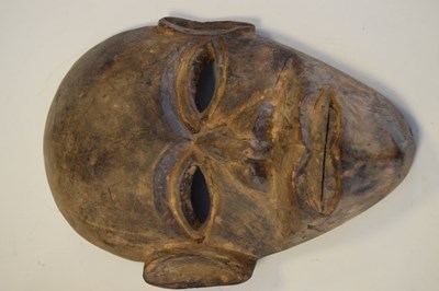 Lot 288 - Three African carved hardwood masks and pair of carved wooden feet