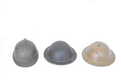 Lot 426 - French 'Adrian' steel helmet and two British 'Brodie' steel helmets