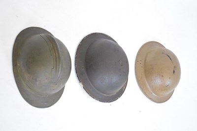 Lot 426 - French 'Adrian' steel helmet and two British 'Brodie' steel helmets