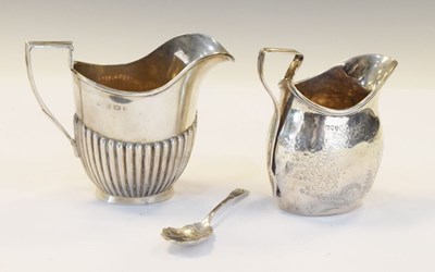 Lot 151 - Two silver milk jugs and spoon