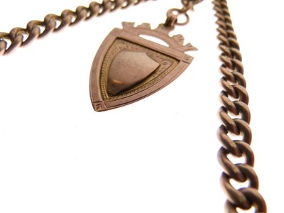 Lot 98 - Yellow metal (9ct) 'rose gold' curb-link Albert and 9ct gold shield fob