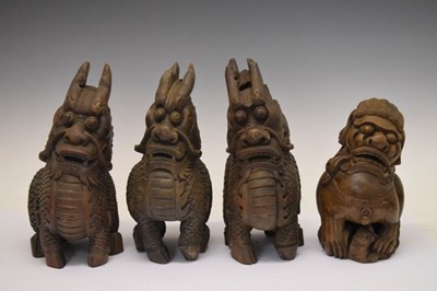Lot 155 - Four South East Asian carved Temple Dogs