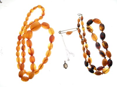Lot 93 - Two strings of amber beads, amber bar brooch and smoky quartz pendant