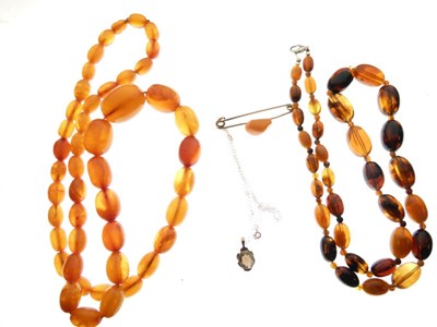 Lot 72 - Two amber beads, amber bar brooch and smoky quartz pendant
