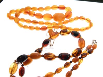Lot 93 - Two strings of amber beads, amber bar brooch and smoky quartz pendant