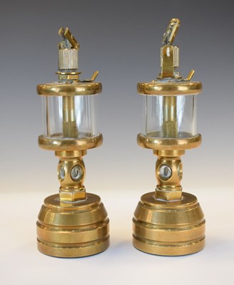 Lot 215 - Pair of small brass table lighters