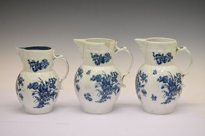 Lot 263 - Three Caughley blue and white cabbage leaf-moulded mask jugs