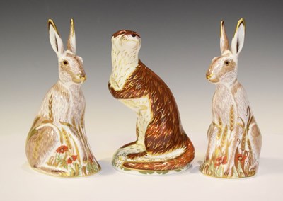 Lot 301 - Three Royal Crown Derby figures, a pair of Midsummer Hares and Playful Otter