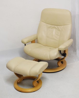 Lot 513 - Ekones 'Stressless' tan leather swivel easy chair and matching footstool