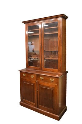 Lot 592 - 20th Century glazed door bookcase on cabinet base