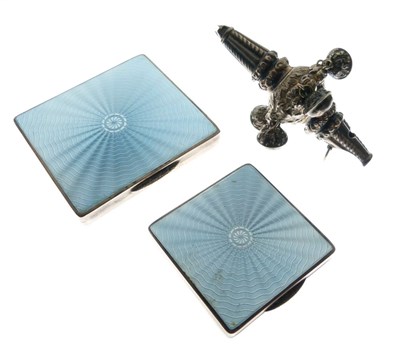 Lot 177 - Two Art Deco silver and light blue enamel compacts and child's rattle