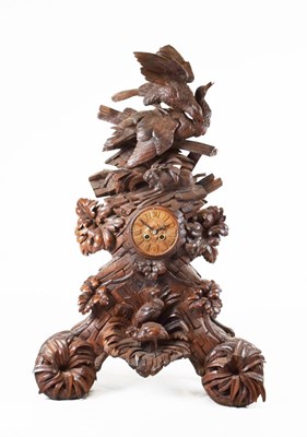 Lot 629 - Impressive Black Forest carved linden wood table clock