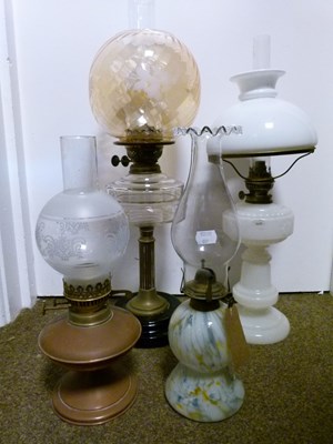 Lot 751 - Group of four late 19th/early 20th century cast metal and glass oil lamps