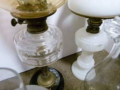 Lot 751 - Group of four late 19th/early 20th century cast metal and glass oil lamps