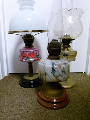 Lot 752 - Group of three early 20th century cast metal and glass oil lamps