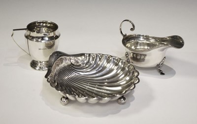 Lot 178 - Edward VII silver shell butter dish, sauce boat and jug