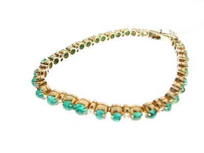 Lot 54 - Yellow metal, emerald and diamond 'tennis' bracelet