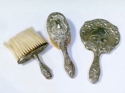Lot 239 - Edward VII silver Art Nouveau hand mirror and brush