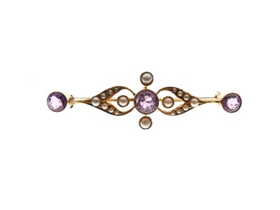 Lot 145 - Edwardian yellow metal (15ct), amethyst and seed pearl bar brooch, and a yellow metal (15ct) tie pin