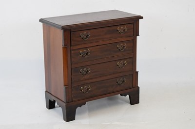 Lot 671 - Mahogany diminutive chest of four long drawers