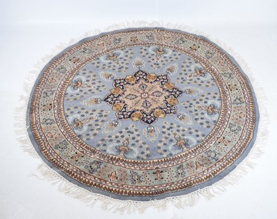 Lot 567 - Circular blue ground wool rug with central medallion