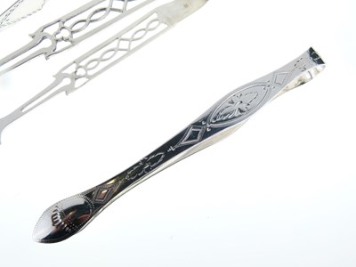 Lot 65 - Three pairs of George III silver sugar tongs, two with bright cut decoration