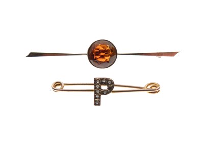 Lot 146 - Unmarked yellow metal bar brooch set amber coloured stone, and another set 'P' with seed pearls