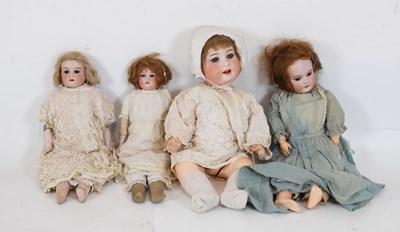 Lot 392 - Early 20th Century bisque headed doll with two unmarked examples