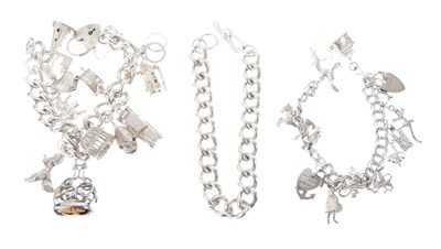 Lot 31 - Two silver charm bracelets, and a heavy curb-link silver bracelet