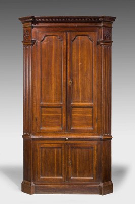 Lot 576 - George III oak floor-standing corner cabinet