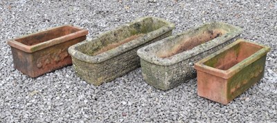 Lot 557 - Pair of composite stone troughs, and a pair of terracotta rectangular planters