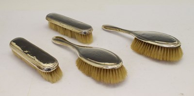 Lot 120 - George V silver four piece dressing set