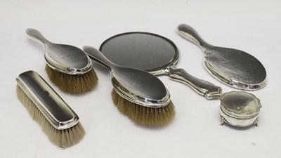 Lot 132 - Three George VI silver dressing table brushes plus two mirrors and a trinket pot