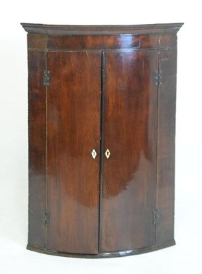 Lot 615 - George III mahogany bowfront corner cupboard