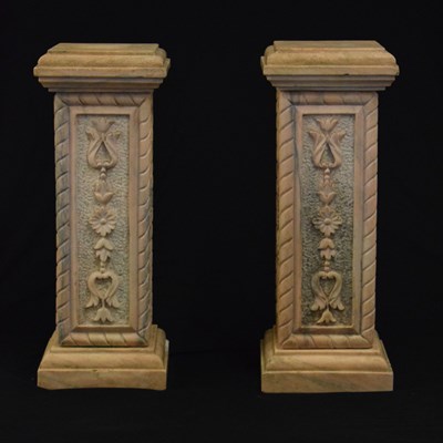 Lot 597 - Pair of pink carved pedestals