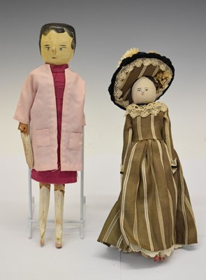 Lot 204 - Two wooden peg dolls