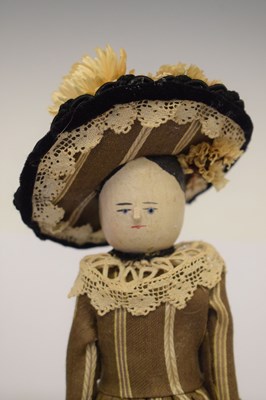 Lot 204 - Two wooden peg dolls